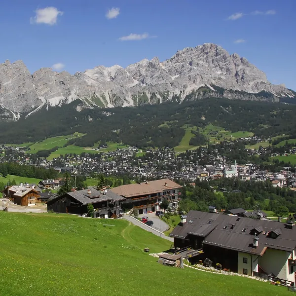Wide view over Cortina d'Ampezzo from the surrounding ridges with the Boite valley below and the Ampezzo Dolomites on the horizon