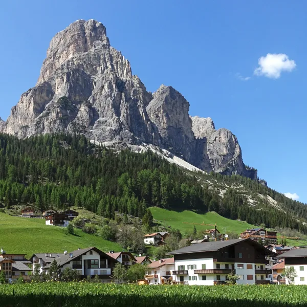 Corvara in Badia with the Sassongher rock tower above the village in the heart of the Ladin Dolomites
