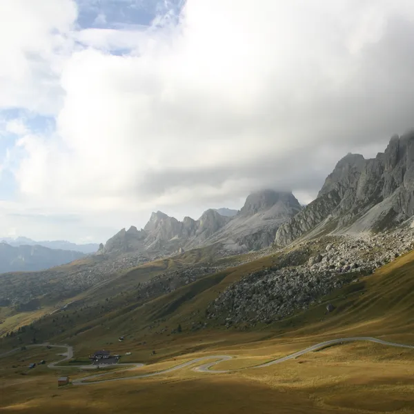 The Passo Giau road crossing the high pastures
