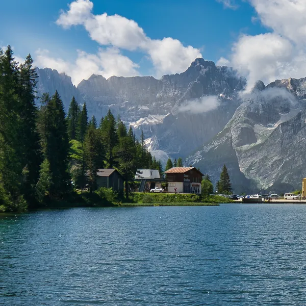 Lake Misurina in summer, the hotel on the shore and the walls of the Cadini and Tre Cime above