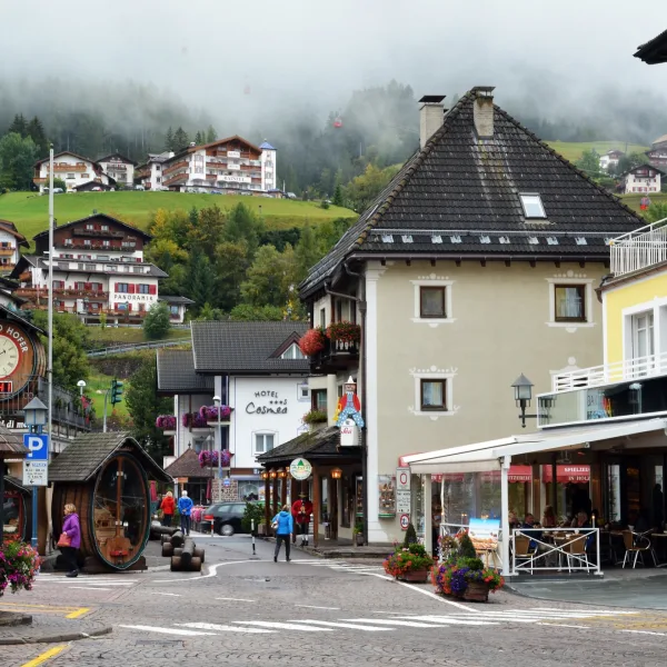 Ortisei (St. Ulrich) town centre with traditional South Tyrolean architecture and the Odle spires above the valley