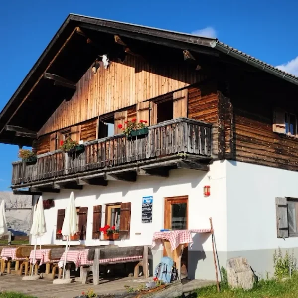 Rifugio Munt de Sennes small mountain hut with a flag flying on the open Sennes plateau