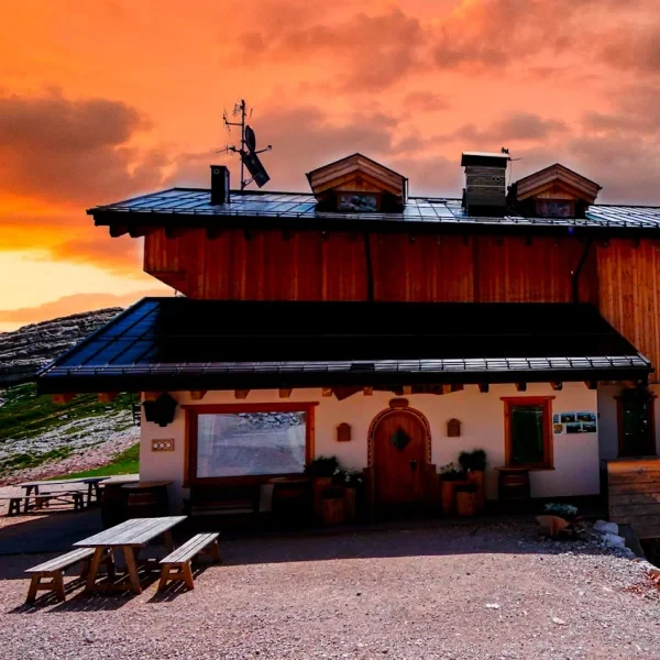 Rifugio Nuvolau perched on its rocky summit overlooking autumn valleys and distant peaks