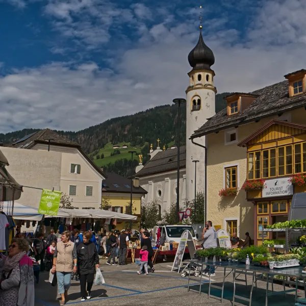 The town of San Candido (Innichen) in the Puster Valley with its collegiate church and traditional South Tyrolean buildings against the Sesto Dolomites
