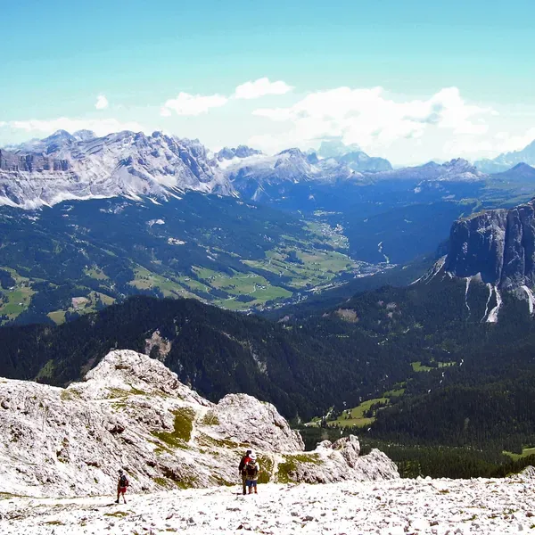 Hikers on the scree of the Forcella de Putia, with the Val Badia below