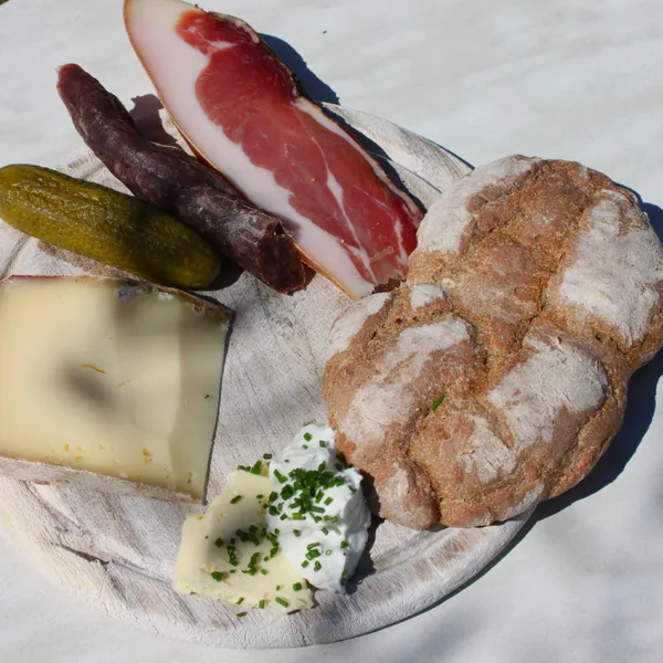 A board of Speck, Kaminwurz, mountain cheese and bread, in South Tyrol