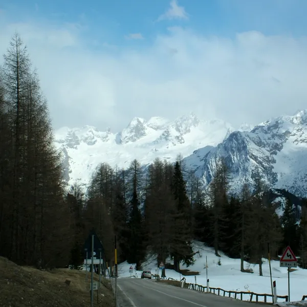 The Sorapis range above Passo Tre Croci in late spring, with snow at the roadside