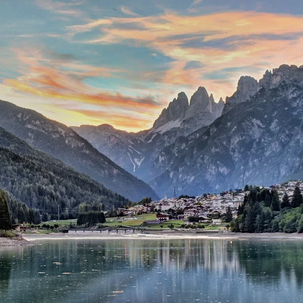 Tre Cime di Lavaredo iconic three peaks rising against a blue sky in the Dolomites
